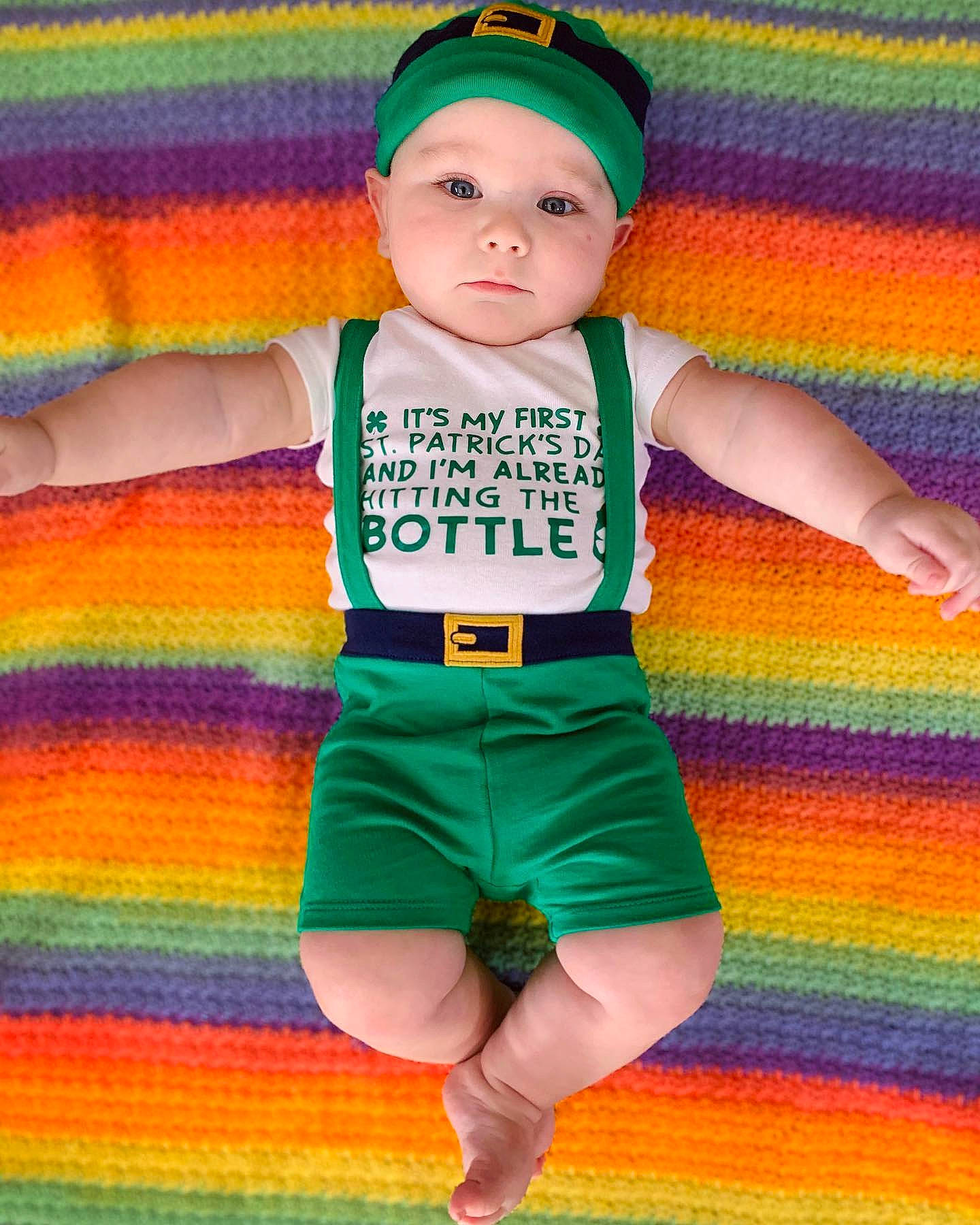 Toby is registered to the contest to win money with this photo: baby_toddler_clothing, board_short, cap, fun, green, happy, headwear, human_body, orange, person, pink, red, shorts, sleeve, sportswear, standing, t_shirt, textile, thigh, toddler