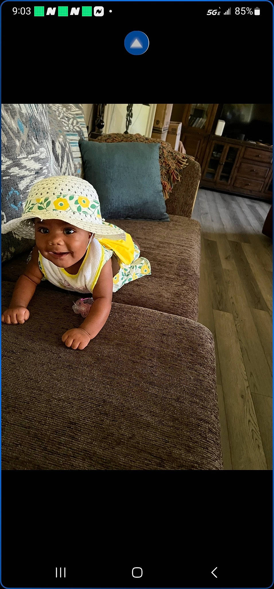 Jewel is registered to the contest to win money with this photo: baby, baby_toddler_clothing, cap, child, comfort, couch, fashion_accessory, flooring, glasses, grass, happy, hat, headwear, linens, pattern, person, plant, smile, t_shirt, tints_and_shades