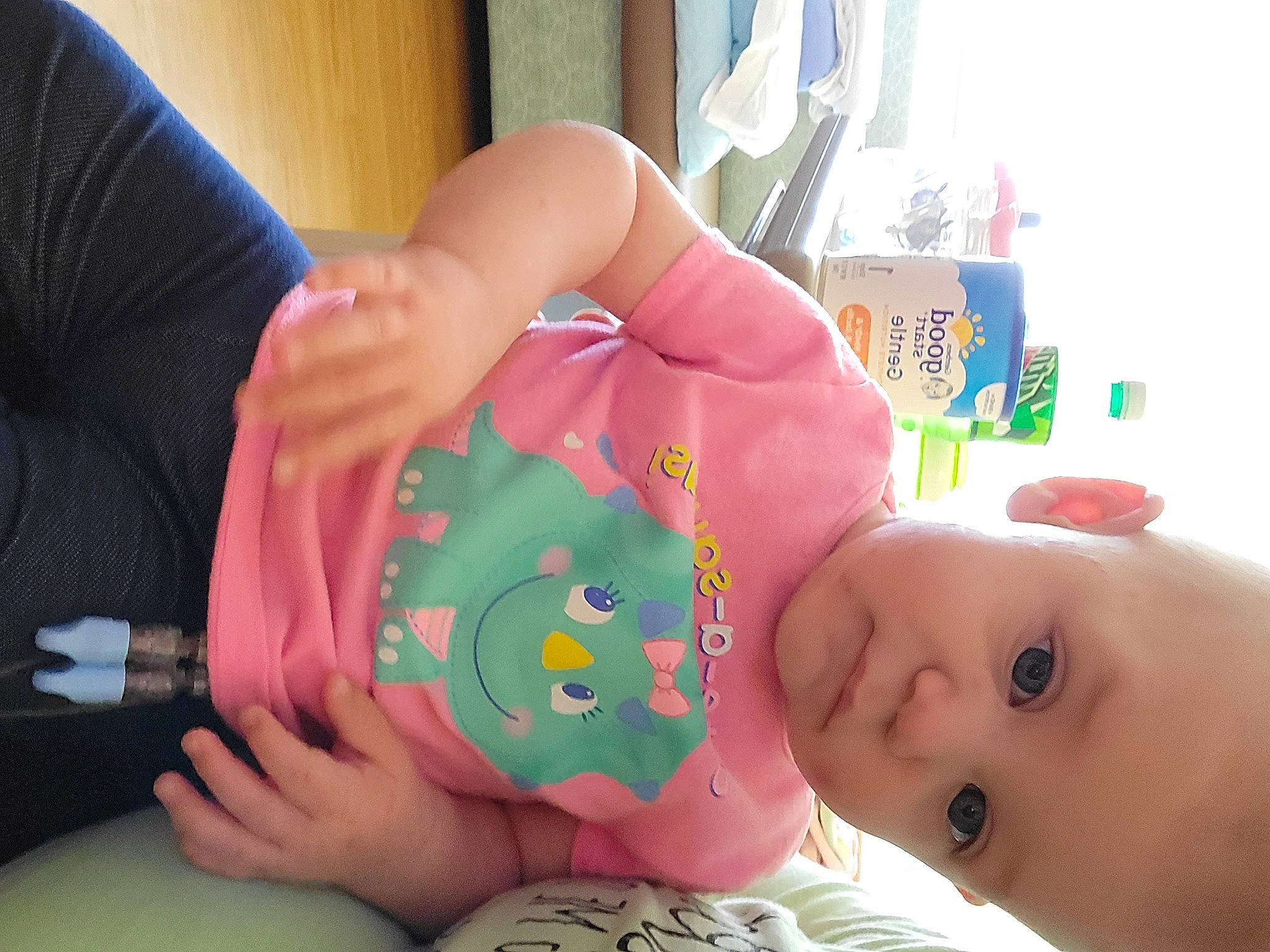 Lucille is registered to the contest to win money with this photo: baby, baby_playing_with_toys, baby_products, baby_toddler_clothing, baby_toys, cheek, child, drinkware, finger, fun, gesture, happy, nail, person, pink, room, skin, thumb, toddler, wrist