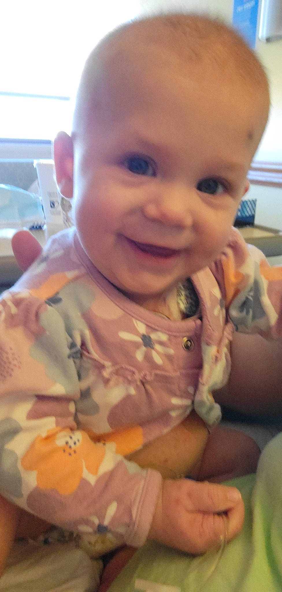 Lucille is registered to the contest to win money with this photo: baby, baby_toddler_clothing, cheek, dress, ear, eye, eyebrow, facial_expression, forehead, hand, happy, human_body, iris, joy, lip, mouth, nose, person, skin, sleeve