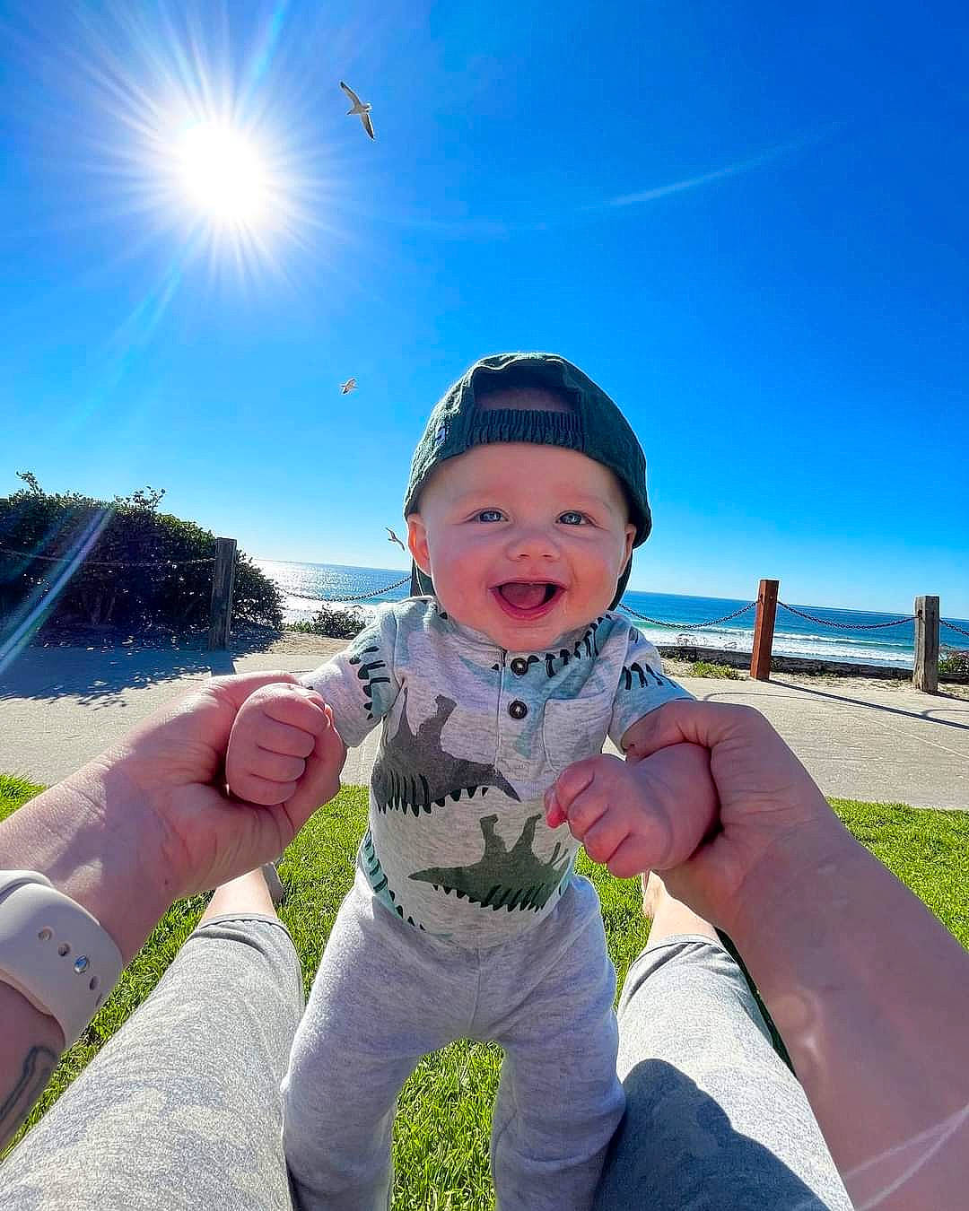 Madden is registered to the contest to win money with this photo: azure, baby, baby_toddler_clothing, beauty, cool, daytime, fun, gesture, grass, happy, hat, headwear, leisure, mammal, people_in_nature, person, recreation, sky, smile, sunlight