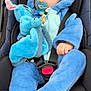 baby, infant, car_seat, blue_onesie, hooded_clothing, plush_toy, pacifier, child, cute, soft_texture, comfort, seated, clothing, hand, face, safety_belt, indoor, calm, snug, adorable
