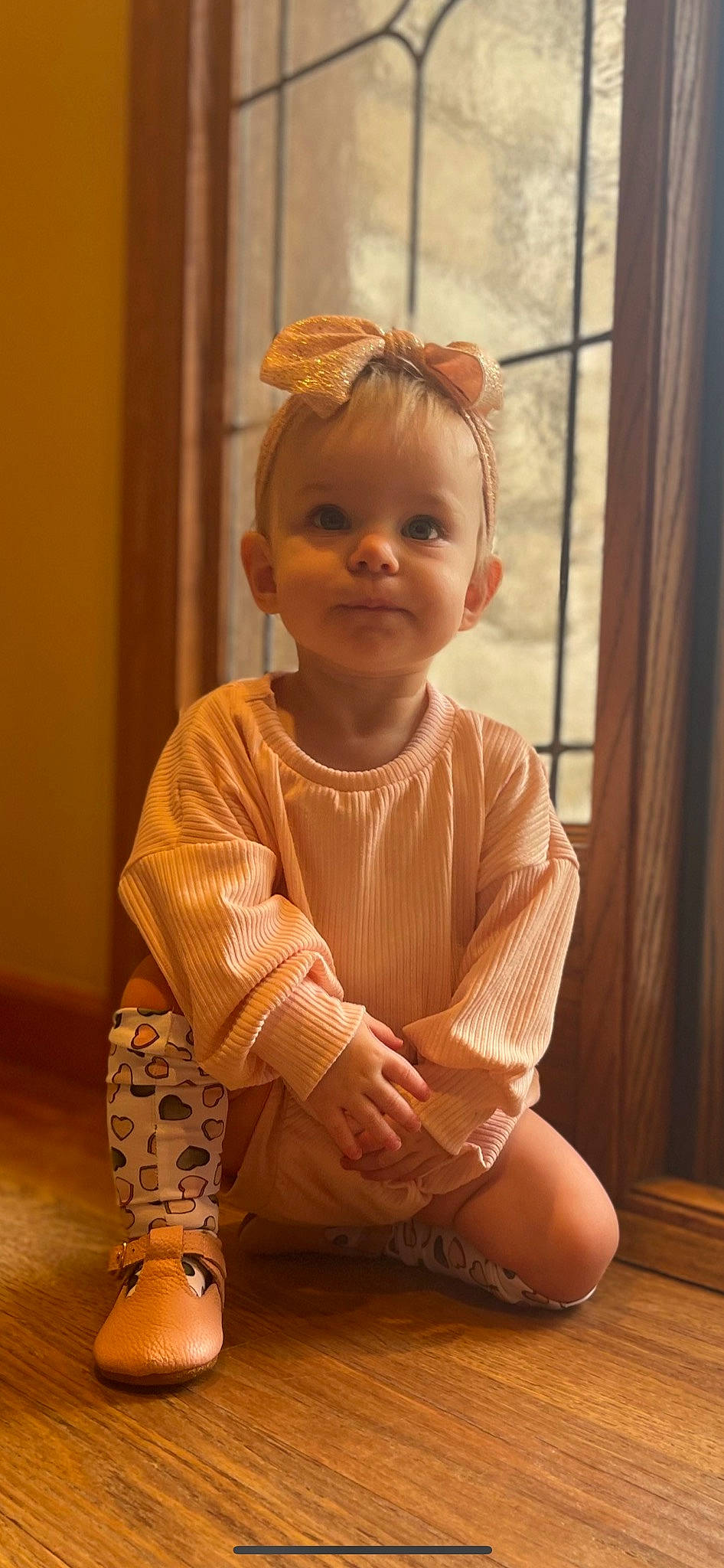 Jocelyn is registered to the contest to win money with this photo: baby, baby_toddler_clothing, blond, cheek, child, curtain, dress, floor, flooring, foot, human_body, human_leg, knee, person, skin, sleeve, smile, toddler, trunk, window