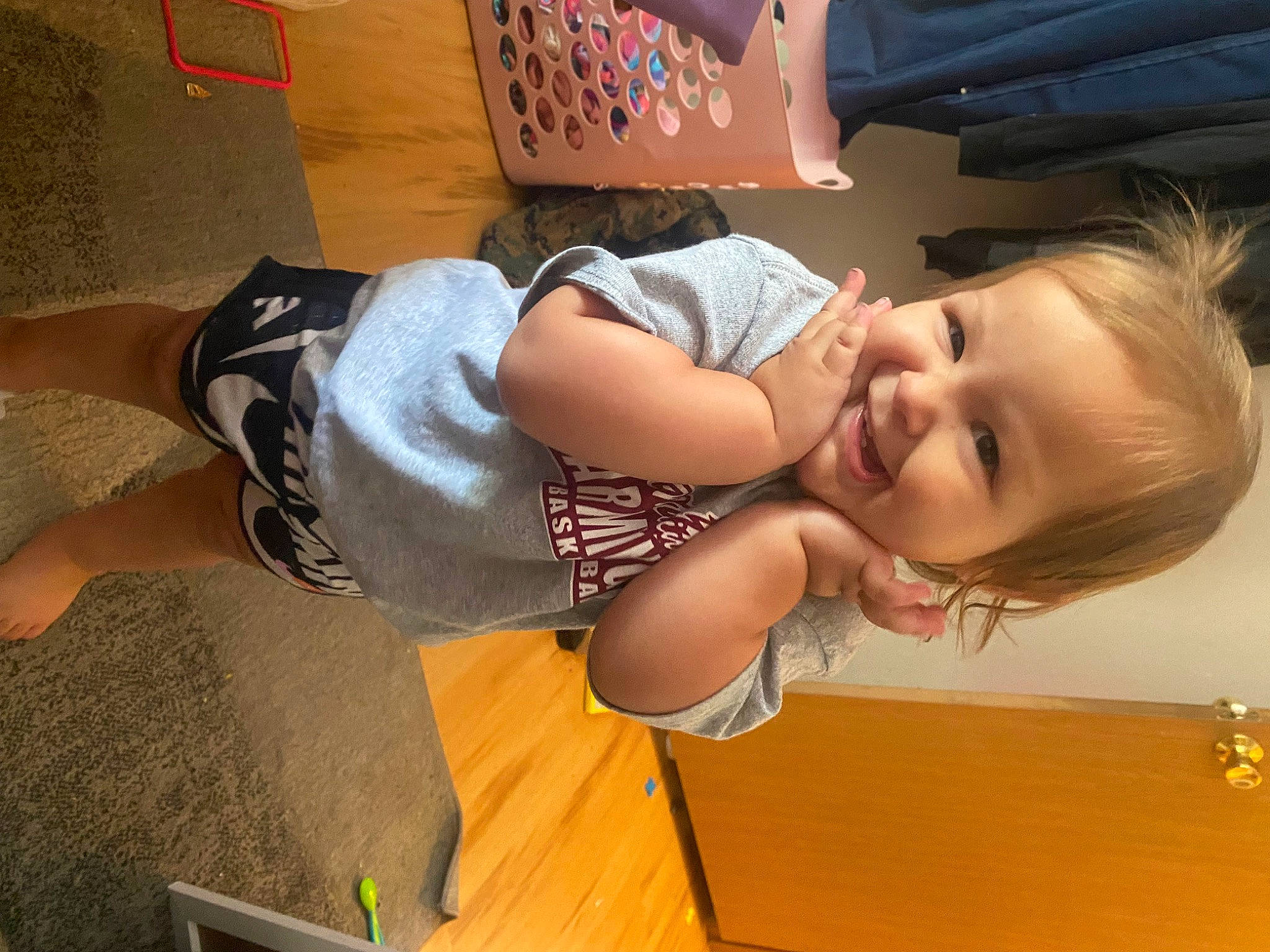 Harper is registered to the contest to win money with this photo: abdomen, baby, child, flooring, foot, fun, happy, human_leg, joy, knee, leisure, mouth, person, play, shorts, sitting, smile, t_shirt, thigh, toddler