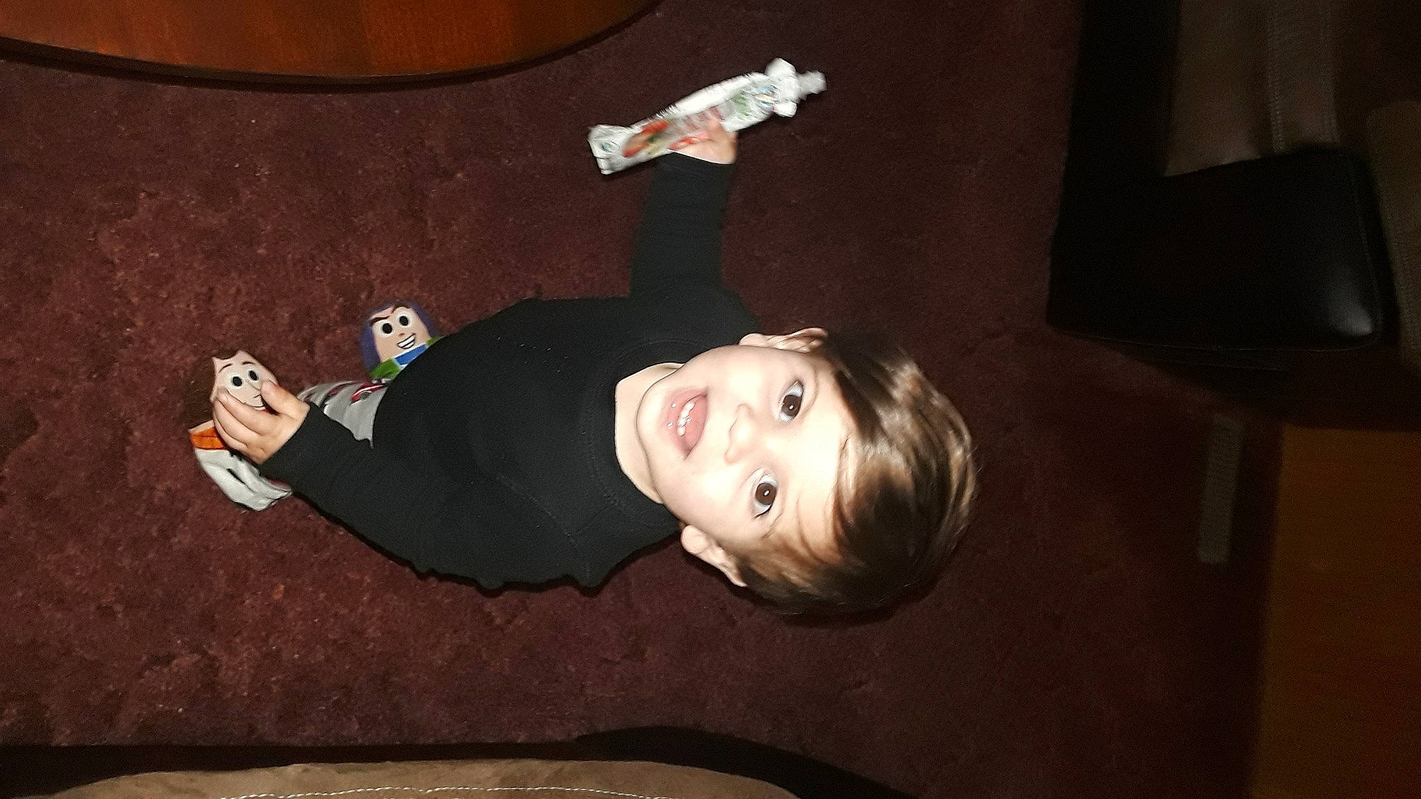 Daxton is registered to the contest to win money with this photo: child, darkness, elbow, flash_photography, flooring, fun, gesture, happy, mouth, person, room, smile, thumb, toddler, wood, wrist
