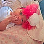 Roxanna joined the competition — help win amazing prizes! baby, infant, newborn, face, hand, headband, bow, pom_pom, blanket, onesie, pink, white, soft_texture, lying_down, cute, child, portrait, indoors, sleepwear, skin