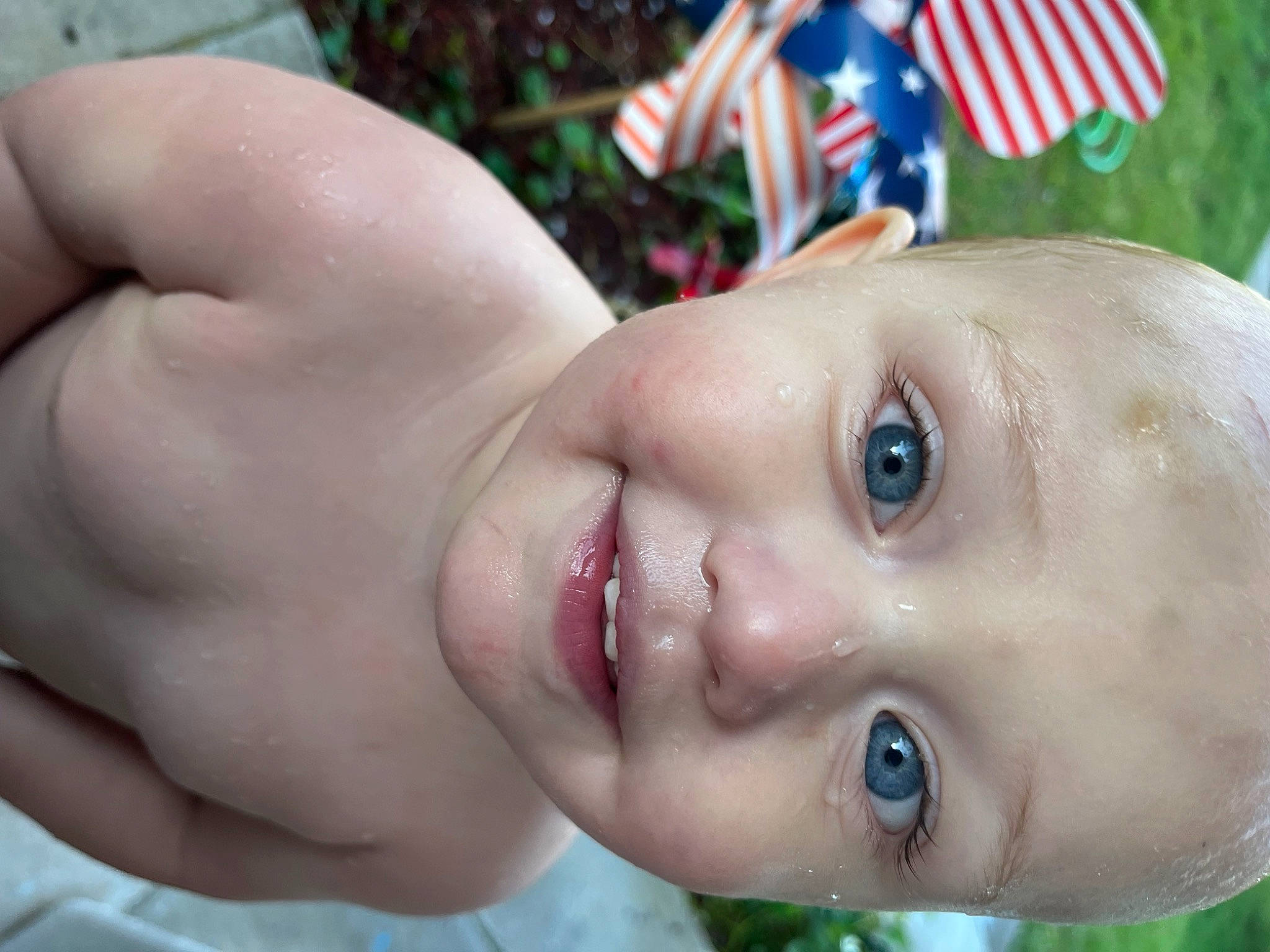 Rodney is registered to the contest to win money with this photo: baby, cheek, chin, eye, eyebrow, eyelash, flag, flag_of_the_united_states, grass, green, happy, iris, joy, lip, nose, person, plant, skin, smile, toddler