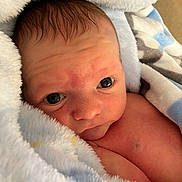 Hayden is registered to the contest to win money with this photo: baby, blanket, face, happy, head, newborn, person, photography, portrait, quilt, smile, towel