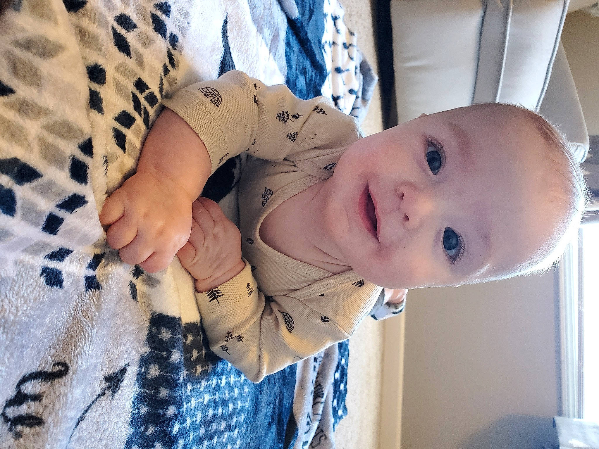 Bentley is registered to the contest to win money with this photo: abdomen, baby, baby_products, baby_toddler_clothing, child, elbow, electric_blue, finger, gesture, hand, happy, iris, nose, pattern, person, room, skin, sleeve, smile, toddler