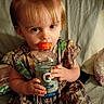 Cheyenne joined the competition — help win amazing prizes! baby, bed, blanket, bottle, camouflage, child, curious, cute, dress, drink, gatorade, green_bows, hair_bows, indoor, person, pillow, portrait, sitting, toddler, young_child