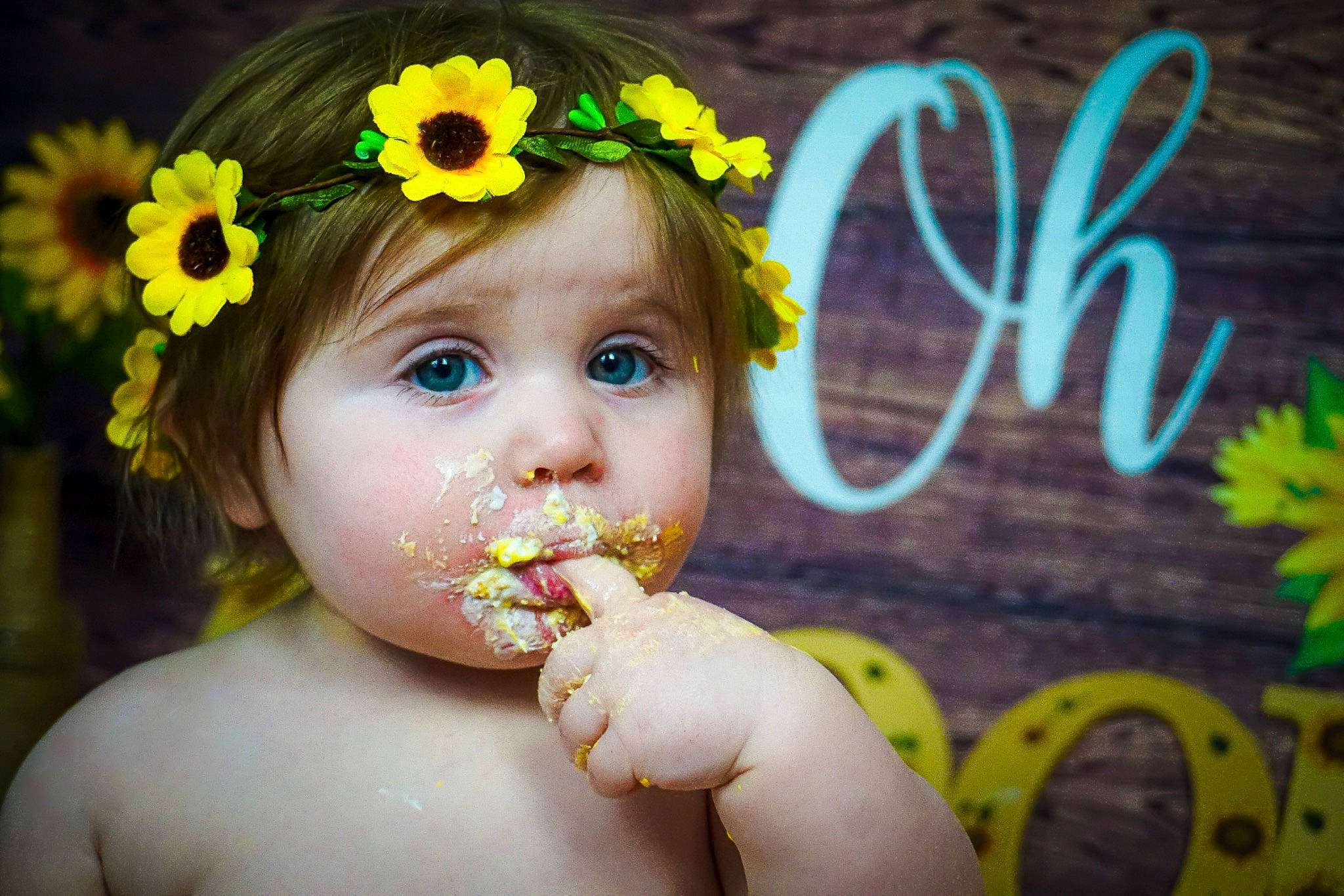 Brooklynn is registered to the contest to win money with this photo: baby, child, eye, eyelash, face, facial_expression, flash_photography, flower, grass, hairstyle, happy, headpiece, iris, nose, people_in_nature, person, petal, plant, skin, toddler