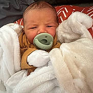 Rowan joined the competition — help win amazing prizes! newborn, baby, pacifier, blanket, mittens, wrapped, infant, cozy, sleepwear, face, head, person, cute, soft, warm, resting, indoors, clothing, child, portrait