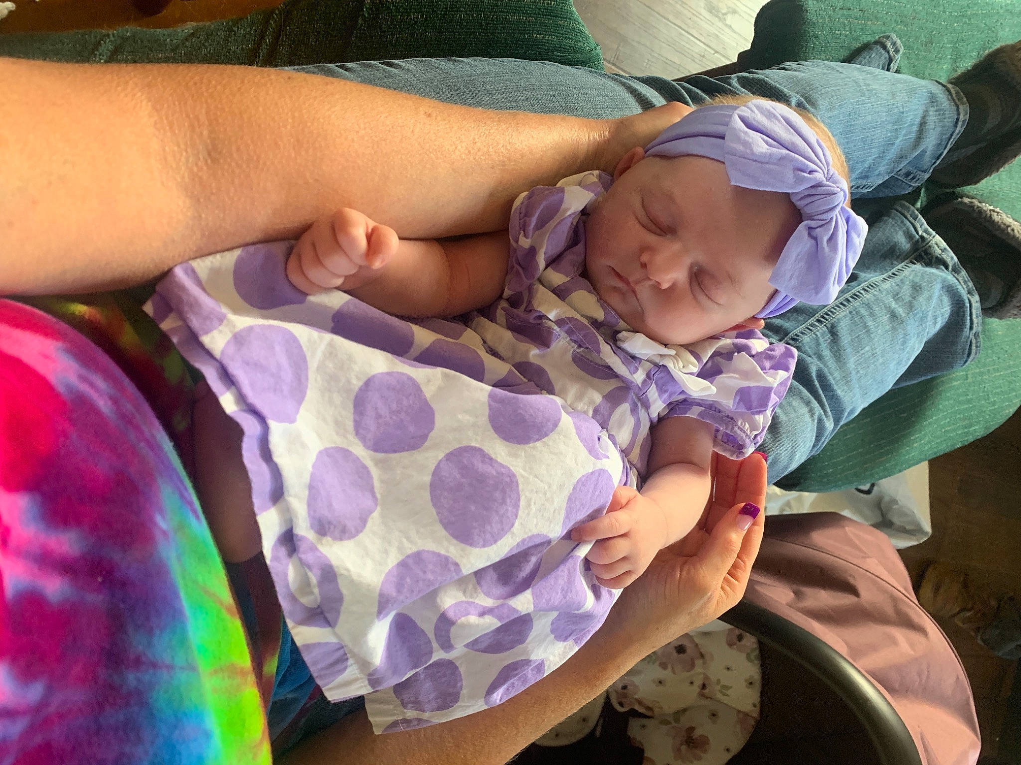 Amethyst is registered to the contest to win money with this photo: baby, baby_products, baby_toddler_clothing, cheek, child, comfort, finger, fun, grass, happy, headwear, lap, linens, nail, pattern, person, purple, sitting, sleeve, thumb