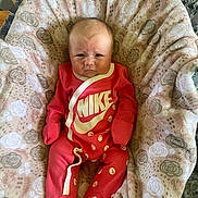 Kylee is registered to the contest to win money with this photo: baby, bed, blanket, clothing, crib, cushion, face, furniture, happy, head, homedecor, infantbed, newborn, pajamas, pants, person, photography, portrait, quilt, sleeping