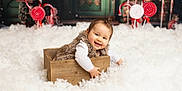 Aya participe au concours pour gagner de l'argent avec cette photo : baby, infant, smiling, face, wooden_box, fur_vest, snow, fake_snow, candy_cane, lollipop, christmas, holiday, festive, studio, portrait, cute, playful, cozy, toy_props, background