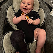 Malakai joined the competition — help win amazing prizes! baby, smiling, infant, onesie, black_clothing, baby_seat, cast, leg_cast, cushion, dimples, happy, child, cute, indoor, seat, baby_toy, portrait, skin, human, comfort