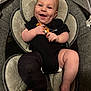 baby, smiling, infant, onesie, black_clothing, baby_seat, cast, leg_cast, cushion, dimples, happy, child, cute, indoor, seat, baby_toy, portrait, skin, human, comfort