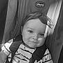 baby, child, car_seat, chicco, smile, face, straps, clothing, toddler, seat_belt, infant, portrait, striped_shirt, sitting, cute, young_child, hair, indoors, monochrome, shadow
