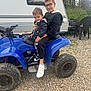 atv, blue, camper, casual, child, children, glasses, grass, gravel, happy, jacket, nature, outdoor, plastic_chairs, play, siblings, smiling, sneakers, trees, vehicle