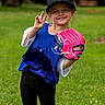 child, girl, baseball, glove, cap, peace_sign, outdoor, grass, sport, smiling, young, cute, athlete, recreation, team, fun, activity, portrait, casual, happy