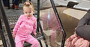 Khaleecy is registered to the contest to win money with this photo: adult, aircraft, boots, canada, casual, child, curious, exhibit, floor, handrail, indoor, jacket, metal_stairs, museum, person, pink_clothing, playful, reflection, standing, toddler