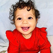Alianna joined the competition — help win amazing prizes! baby, bright_colors, cheerful, child, clothing, curly_hair, cute, eye_contact, face, happy, indoor, long_sleeve, person, portrait, red_sweater, sitting, smiling, toddler, warm_clothing, young_child