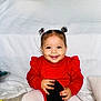 Alianna is registered to the contest to win money with this photo: baby, blanket, carpet, child, cozy, cute, happy, holding, home, indoor, person, pony_tail, portrait, red_sweater, shoe, sitting, smile, toddler, toy, white_tights