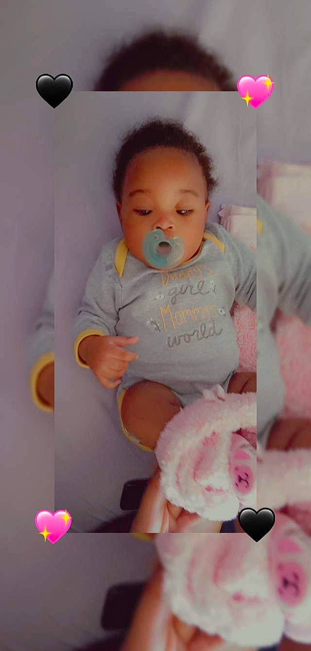 Malani is registered to the contest to win money with this photo: baby, baby_products, baby_toddler_clothing, cheek, child, eyebrow, eyelash, finger, fun, happy, magenta, nose, person, pink, room, sitting, skin, sleeve, smile, t_shirt