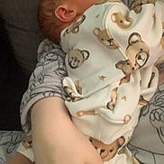 Malachi is registered to the contest to win money with this photo: baby, sleeping, pajamas, bear_print, infant, hand, arm, soft_fabric, patterned_clothing, cozy, rest, close_up, child, person, indoor, cute, comfort, toddler, skin, holding