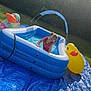Alaiya joined the competition — help win amazing prizes! child, girl, inflatable_pool, water, outdoor, grass, tree, inflatable_duck, sunlight, smiling, blue_tarp, play, summer, pigtails, red_swimsuit, backyard, house, hedge, fun, happy
