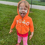 Alaiya Mary Deeter joined the competition — help win amazing prizes! child, orange_hoodie, pink_leggings, grass, outdoor, face_paint, tongue_out, playful, smiling, road, trees, field, casual_clothing, footwear, person, happy, nature, fun, expression, summer