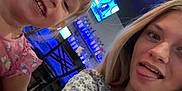 Alaiya Mary Deeter joined the competition — help win amazing prizes! child, young_woman, selfie, smile, tongue_out, indoor, restaurant, bar, television, bottles, chair, table, blonde_hair, casual_clothing, person, face, happy, fun, friends, people