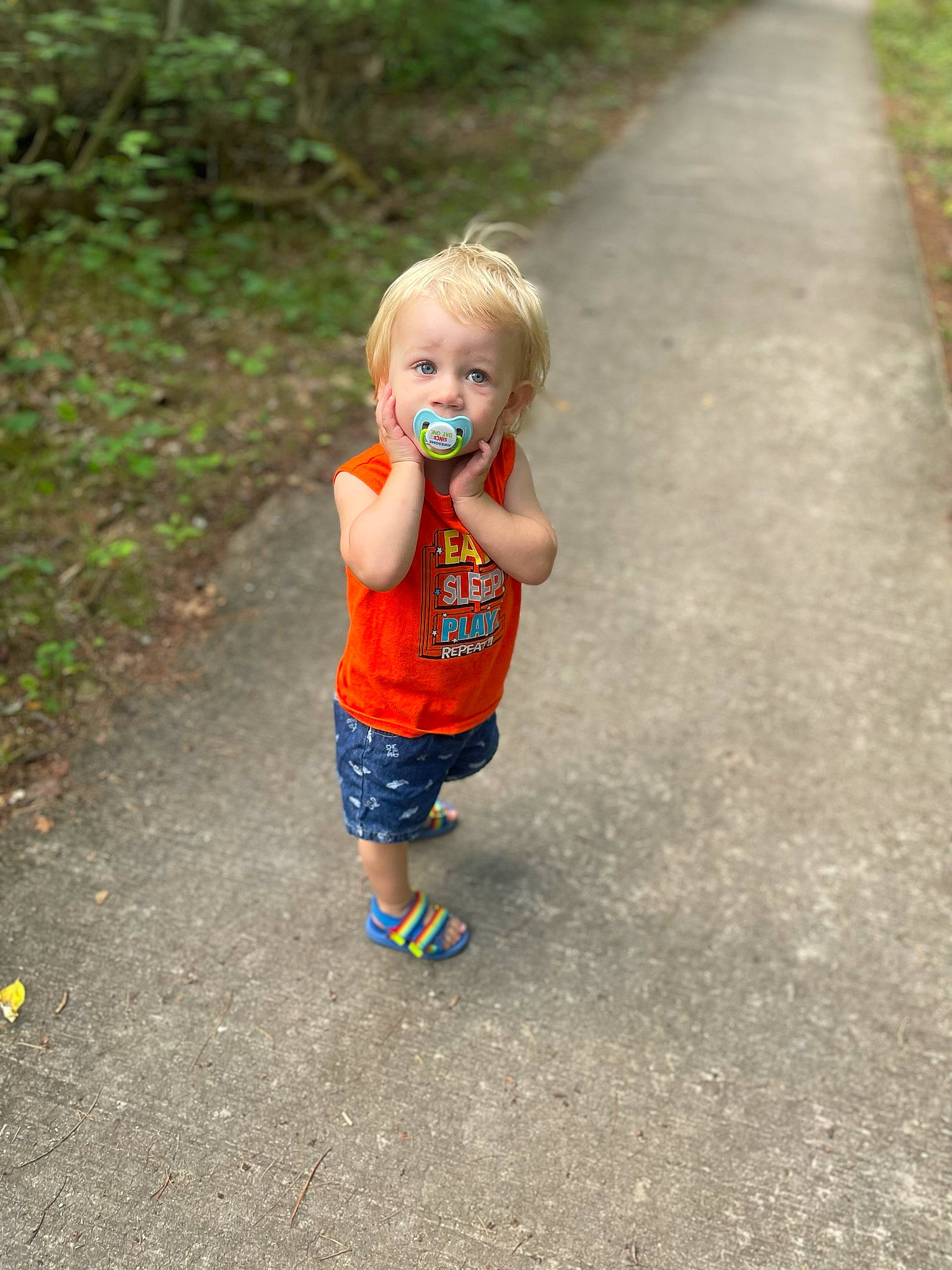 Paul is registered to the contest to win money with this photo: asphalt, baby, baby_toddler_clothing, child, electric_blue, fun, grass, happy, human_leg, leisure, people_in_nature, person, plant, play, recreation, road, road_surface, shorts, sidewalk, toddler
