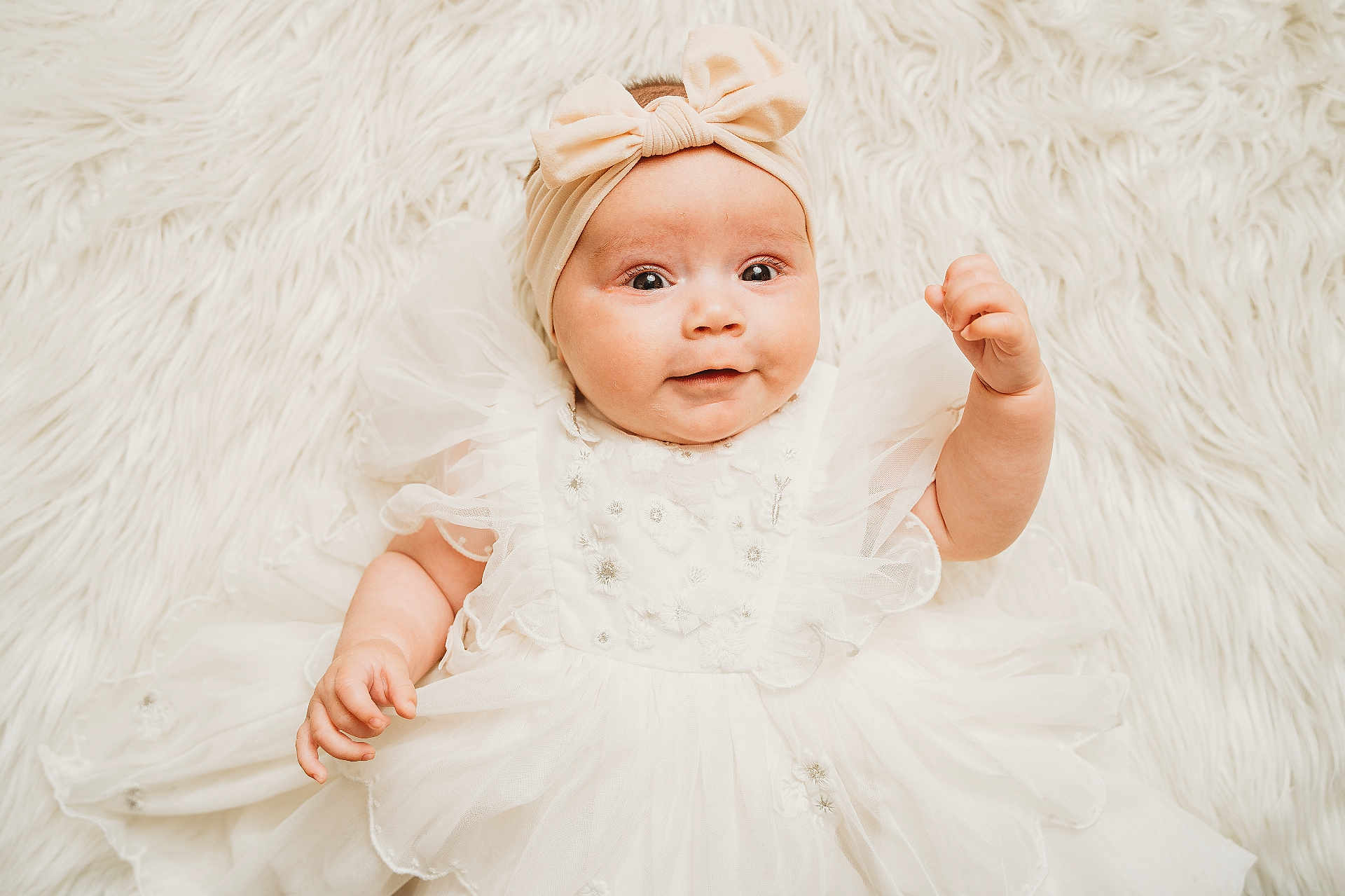 Liliana is registered to the contest to win money with this photo: baby, infant, child, white_dress, headband, bow, fluffy_background, cute, portrait, smiling, lying_down, soft_texture, adorable, closeup, baby_fashion, innocent, happy, person, toddler, charming