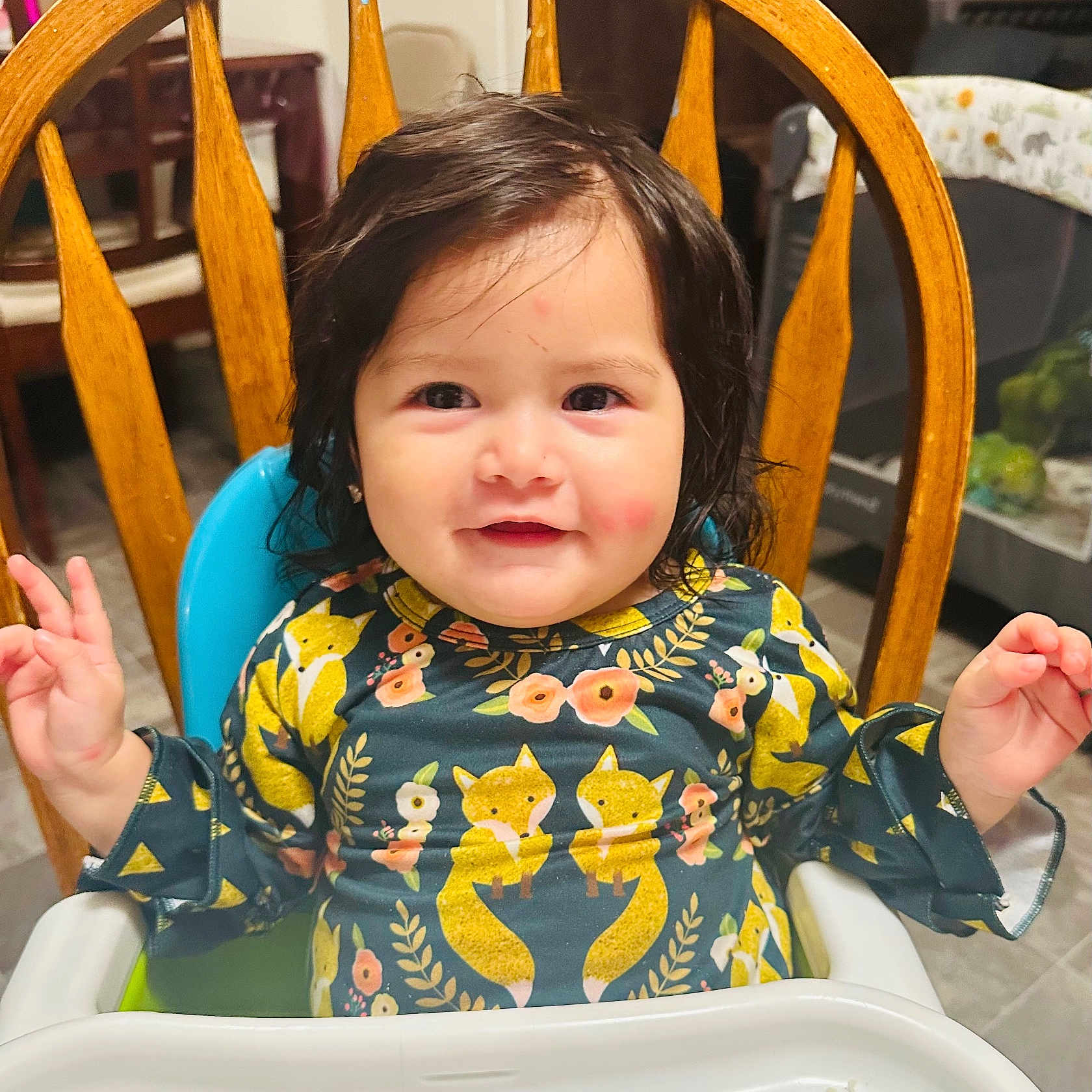 Nahomy joined the competition — help win amazing prizes! baby, child, clothing, cute, dining_room, face, fox_print, furniture, hair, happy, high_chair, indoor, infant, patterned_shirt, person, rosy_cheeks, small_hands, smiling, table, wooden_chair