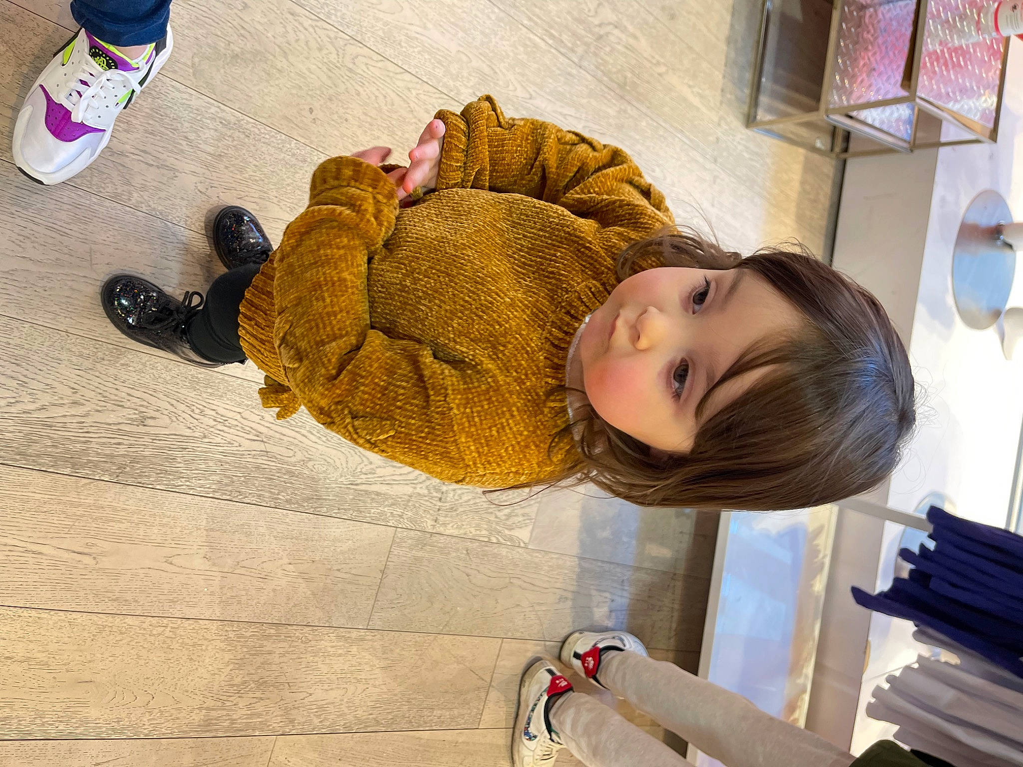 Lilianna is registered to the contest to win money with this photo: child, comfort, cross_training_shoe, floor, flooring, foot, fun, fur, happy, human_leg, jacket, leg, person, photograph, room, sitting, snapshot, toddler, tree, walking_shoe