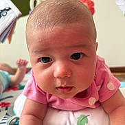 Aliz joined the competition — help win amazing prizes! baby, infant, child, face, eyes, pink_shirt, play_mat, toy, curious, drool, skin, head, arm, indoor, closeup, portrait, cute, expression, young, laying