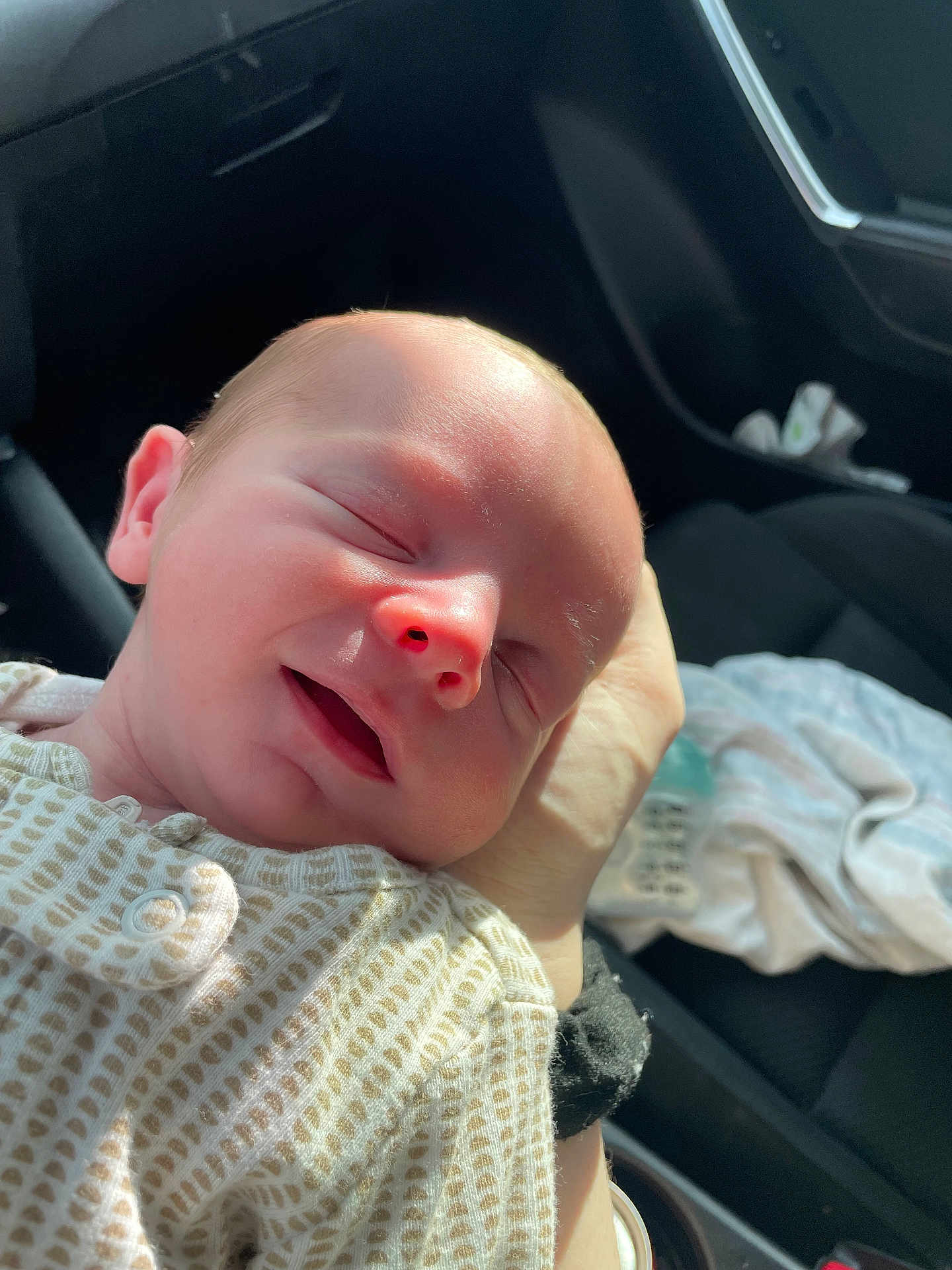 Carter joined the competition — help win amazing prizes! newborn, baby, infant, sleeping, hand, skin, onesie, pattern, face, closed_eyes, car_interior, seat, blanket, light, shadow, closeup, portrait, peaceful, soft, child