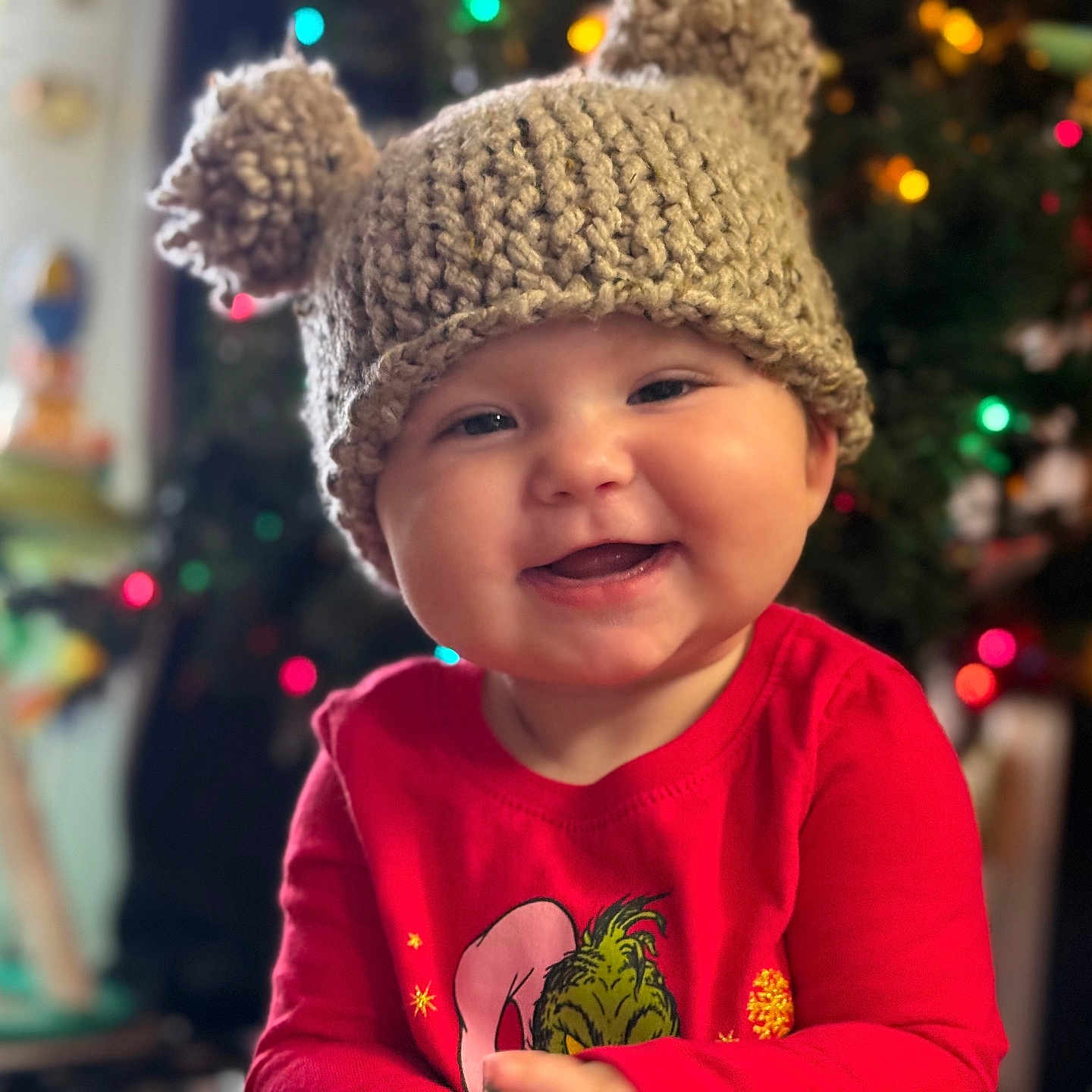 Arya is registered to the contest to win money with this photo: baby, beanie, bodypart, bonnet, cap, clothing, face, finger, glove, hand, happy, hat, head, knitwear, person, photography, portrait, smile, sweater, t_shirt