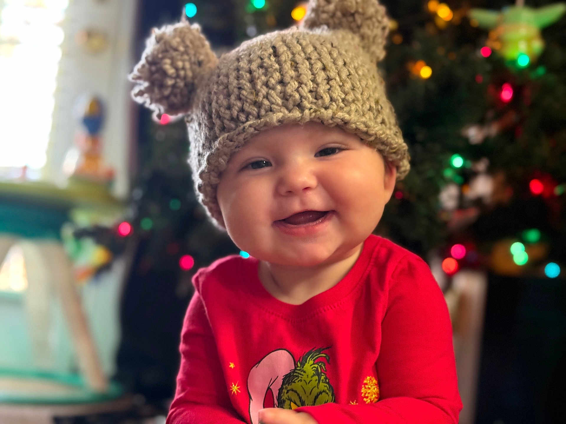 Arya is registered to the contest to win money with this photo: baby, beanie, bodypart, bonnet, cap, clothing, face, finger, glove, hand, happy, hat, head, knitwear, person, photography, portrait, smile, sweater, t_shirt
