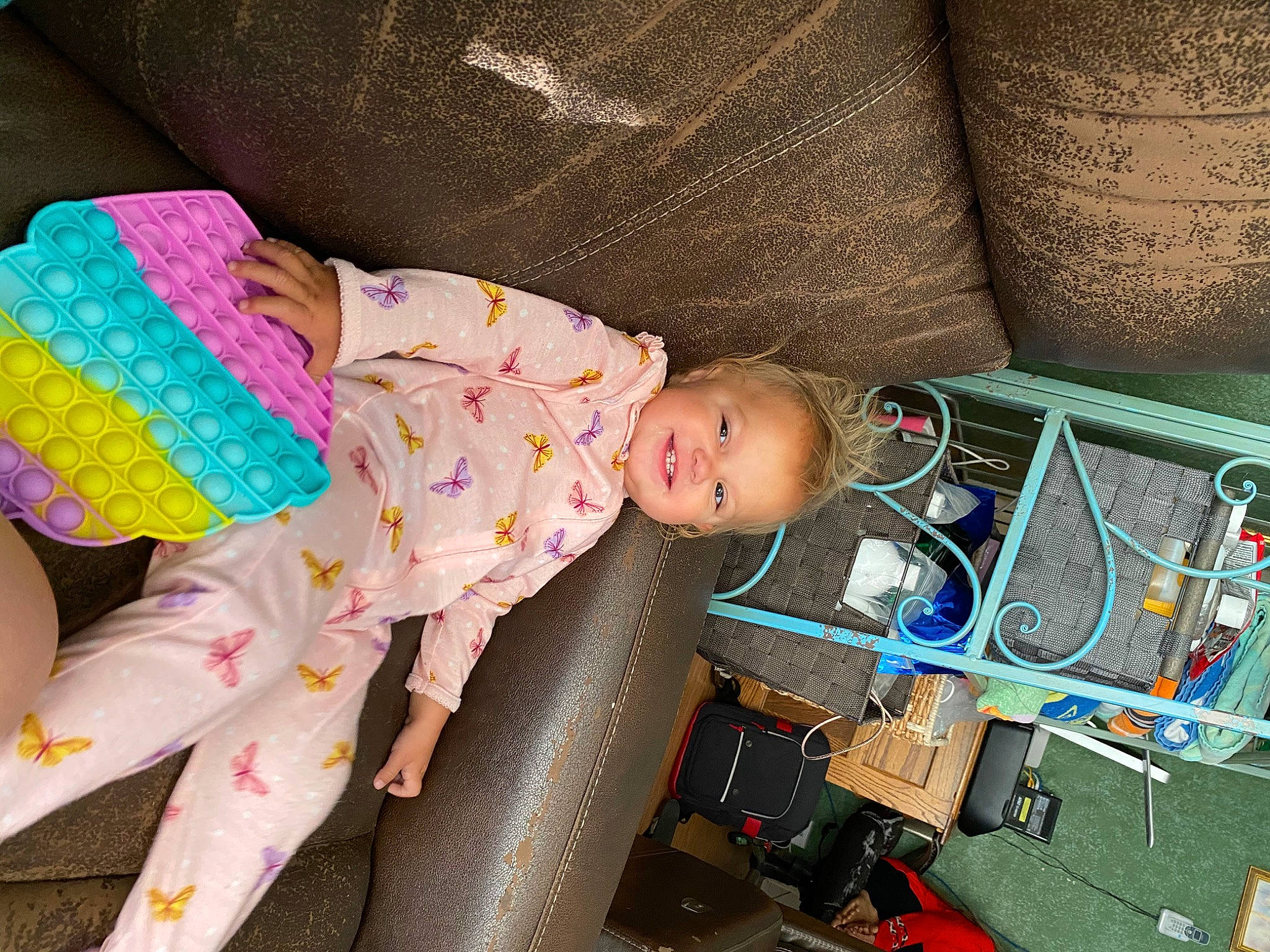 Amelia is registered to the contest to win money with this photo: audio_equipment, baby, baby_products, baby_toddler_clothing, baby_toys, child, comfort, couch, electrical_wiring, joy, linens, machine, pattern, person, play, product, room, sitting, sleeve, textile