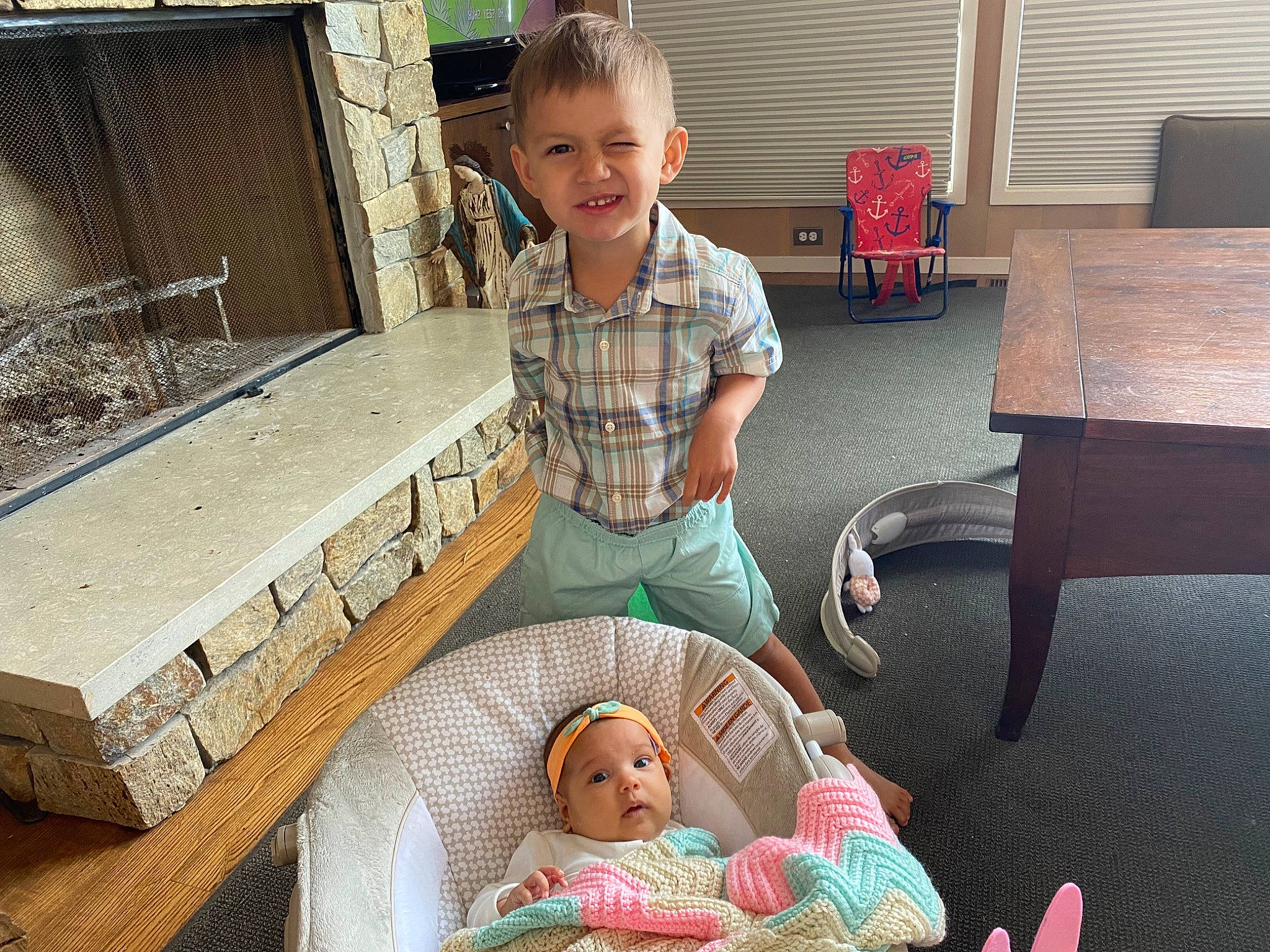 Isiah is registered to the contest to win money with this photo: baby, baby_toddler_clothing, chair, child, comfort, doll, event, eye, face, fun, happy, head, headwear, human_body, joy, lap, leisure, person, sharing, skin