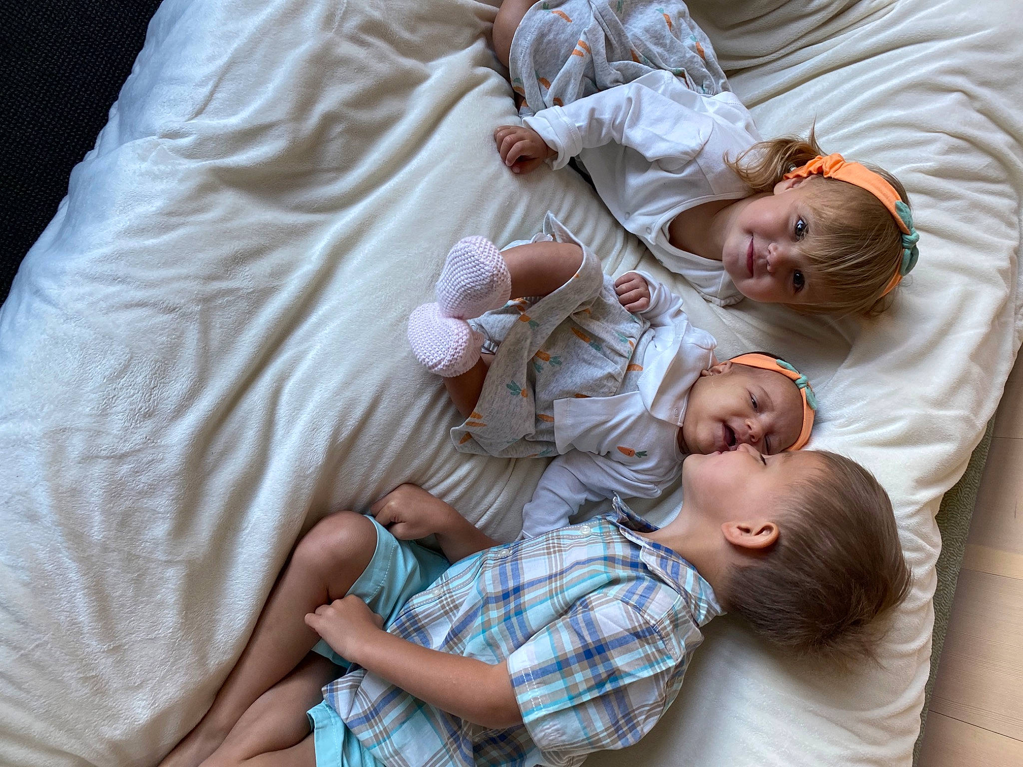 Isiah is registered to the contest to win money with this photo: arm, baby, baby_toddler_clothing, child, comfort, couch, facial_expression, gesture, hand, happy, headwear, interaction, joint, joy, linens, mouth, person, sitting, skin, sleeve