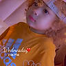 Adonis joined the competition — help win amazing prizes! child, portrait, curly_hair, baseball_cap, yellow_shirt, smiling, face, eyes, indoor, seated, close_up, colorful_lighting, purple_lighting, orange_clothing, bed, furniture, photography, heart_design, date_text, casual_style