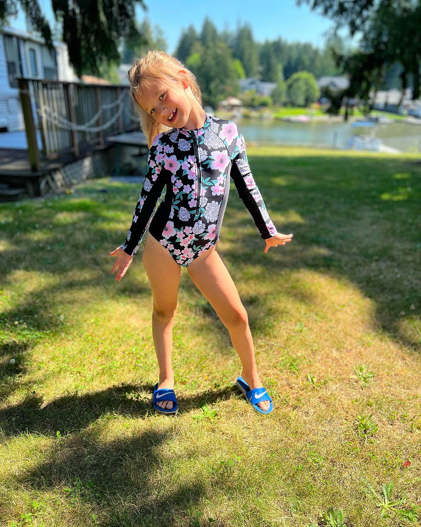 Rosie is registered to the contest to win money with this photo: barefoot, denim, electric_blue, eyewear, grass, grassland, happy, human_leg, joy, lawn, leisure, meadow, pattern, people_in_nature, person, plant, recreation, sandal, sky, tree