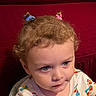 Nikolai joined the competition — help win amazing prizes! toddler, child, face, hair_ties, curly_hair, colorful_clothing, patterned_shirt, indoor, portrait, looking_away, expression, cute, young_child, person, sitting, closeup, red_background, soft_lighting, casual, innocent