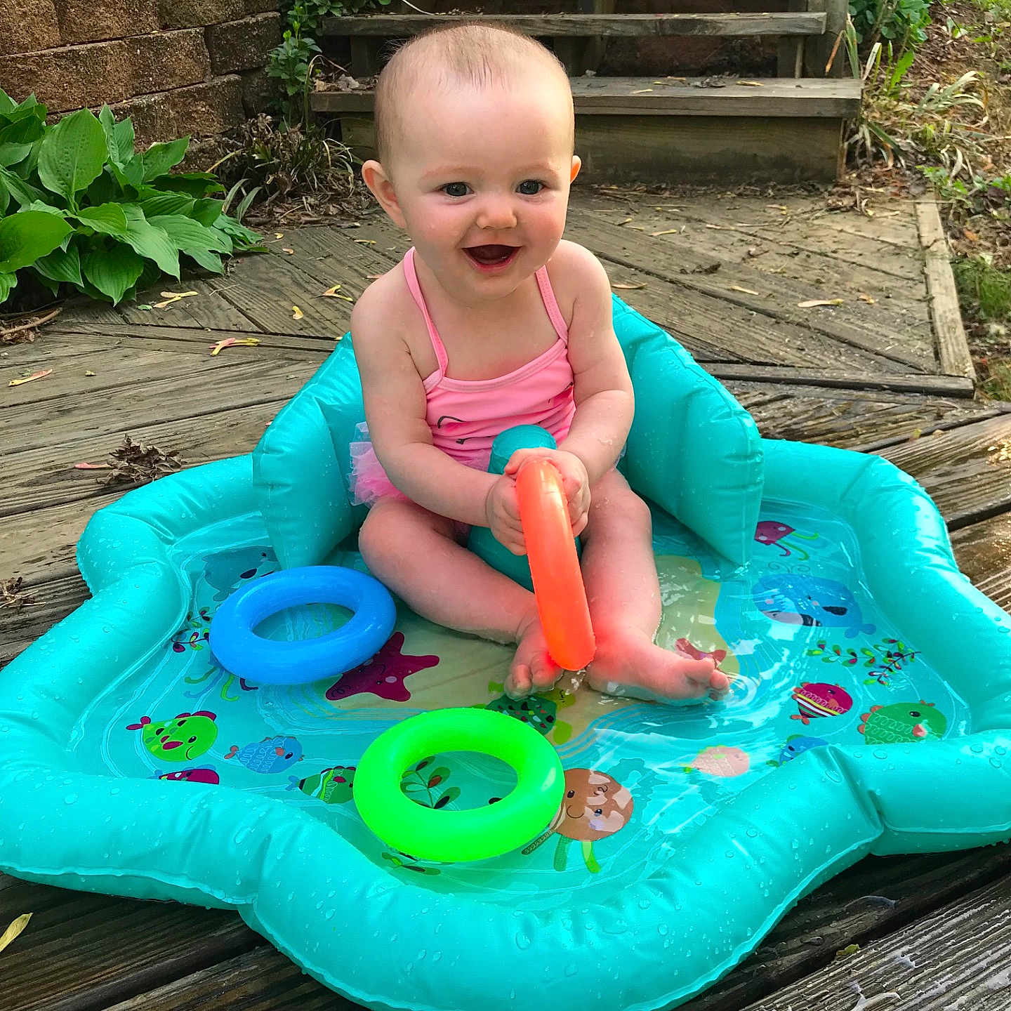 Ella is registered to the contest to win money with this photo: child, chute, fun, girl, grass, green, inflatable, leisure, outdoor_play_equipment, play, playground, playground_slide, recreation, summer, toddler, toy, vacation