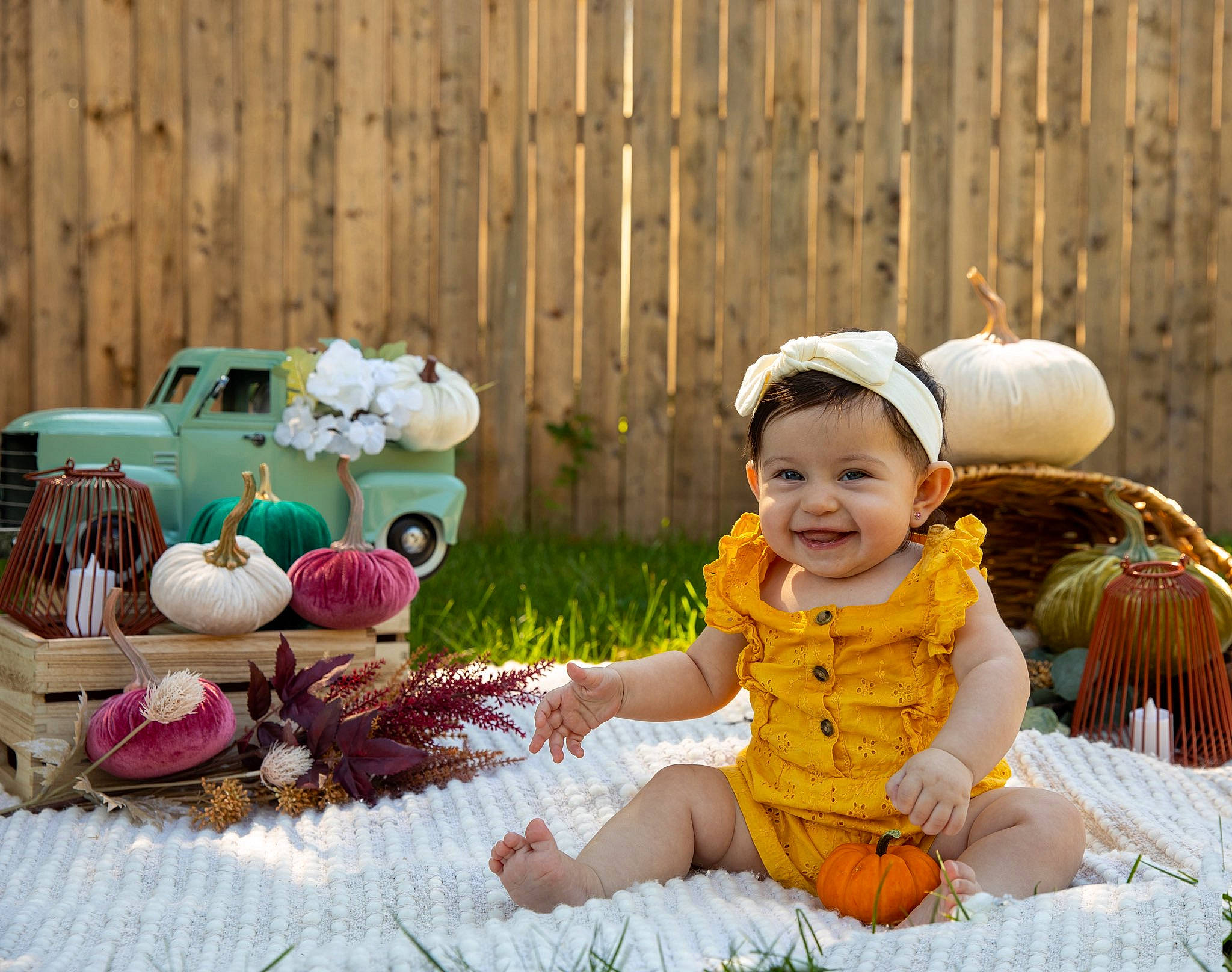 Olivia is registered to the contest to win money with this photo: baby, baby_toddler_clothing, basket, child, event, fence, fun, grass, happy, hat, home_fencing, joy, leisure, people_in_nature, person, plant, sitting, smile, sun_hat, table