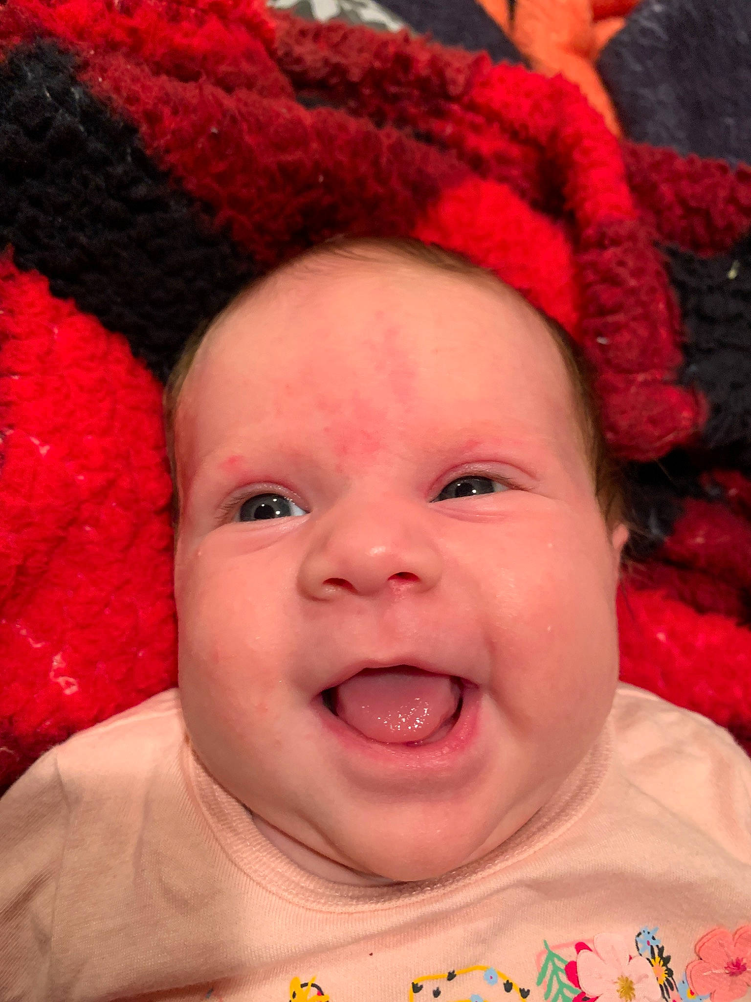 Leigha is registered to the contest to win money with this photo: baby, baby_making_funny_faces, cheek, child, chin, close_up, face, facial_expression, forehead, happy, head, headgear, lip, mouth, nose, person, pink, red, skin, smile