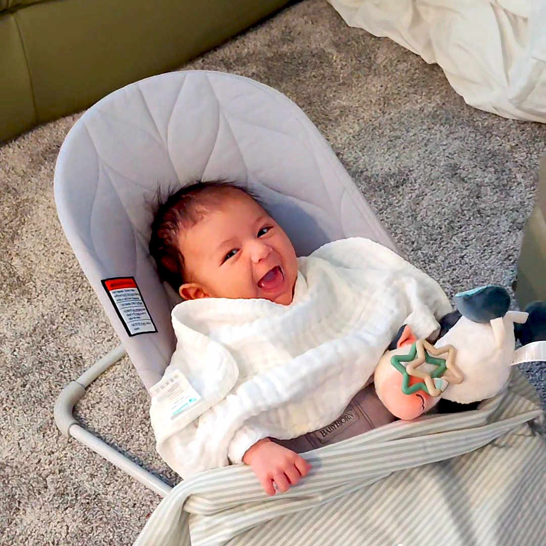 Mason is registered to the contest to win money with this photo: baby, babylaughing, bed, crib, face, furniture, happy, head, infantbed, person